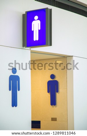 public toilet sign for disabled people and  men on white wall tile at the entrance