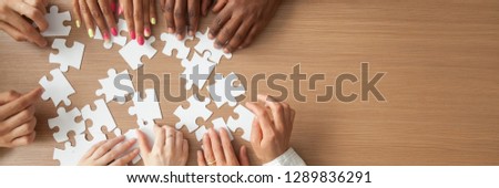 Above top panorama copyspace for text diverse hands people assemble jigsaw puzzle put pieces together search common decision. Support teamwork concept horizontal photo banner for website header design
