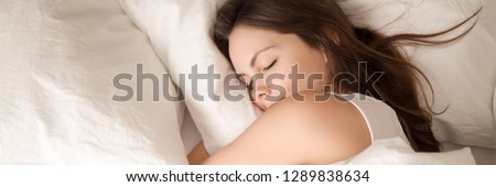 Close up horizontal panoramic photo copy space for text top above view sleeping woman hug pillow rest relax in bed bedroom enjoy comfortable mattress and fresh bedding banner for website header design