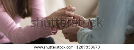 Close up horizontal photo man touch hold hands of beloved woman friend support help symbol, forgiveness apologizing gesture, psychological assistance empathy concept, banner for website header design