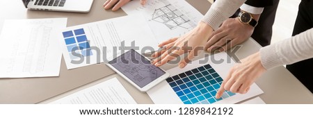 Close up horizontal photo of colleagues interior designers working with color swatches palette and blueprint, planning discussing together creative occupation concept banner for website header design
