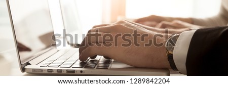Horizontal close up photo businessmen typing on computer hands and keyboard closeup. Worker typing message contacting client by internet online communication concept, banner for website header design