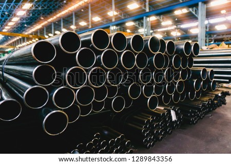 high quality Galvanized steel pipe or Aluminum and chrome stainless pipes in stack waiting for shipment  in warehouse Royalty-Free Stock Photo #1289843356