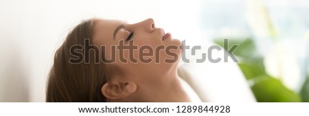 Horizontal photo close up woman face closing eyes sleeping dreaming breathing fresh air rest lying on couch at home, vacation weekend concept, banner for website header design with copy space for text