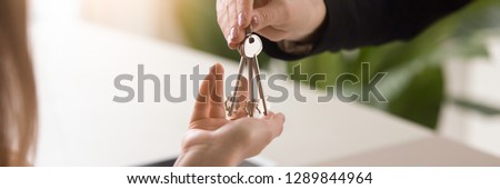 Horizontal photo close up male real estate agent realtor hands give keys to female client, loan mortgage buying selling property new home apartments concept, panoramic banner for website header design