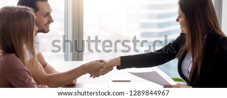 Horizontal concept photo couple shaking hands after signing real estate contract with realtor. Buy purchase property, rent house flat, banner for website header design design with copy space for text