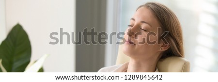 Horizontal close up photo businesswoman worker rest leaning on chair at workplace closed eyes stress relief, dreaming breath fresh air concept banner for website header design with copy space for text
