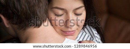 Close up woman face wife closed eyes embracing beloved husband, show love feels relieved. Support apology forgiveness empathy in relationship concept. Horizontal photo banner for website header design