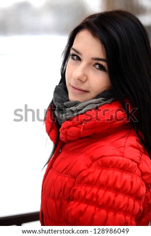 Happy young woman plays with a snow outdoor. Winter day