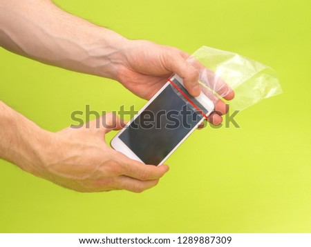 Phone in a plastic transparent bag. Life hack protection from water and dirt