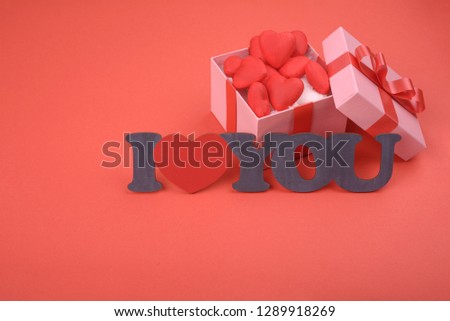 Gift box and inscription i love you on red background. Valentines day, mothers day, holiday.