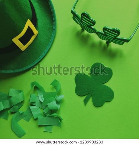 Close On St. Patricks Day Concept On Green Background. Beer and Leprechaun Hat with Confetti