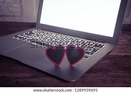 Conceptual image of text Love you in wood blocks on computer with mood romantic screen light background in Valentines day internet connection technology online dating and communication concept.