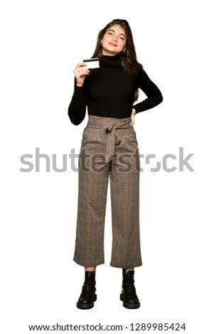 Full-length shot of Pretty girl holding a credit card on isolated white background