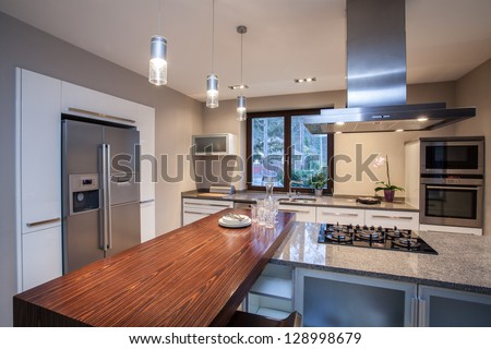 Travertine house- Horizontal view on iluminated kitchen Royalty-Free Stock Photo #128998679