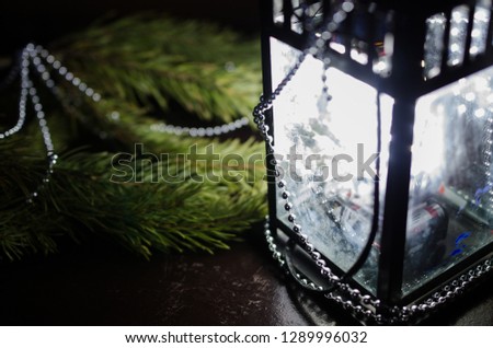Spruce branch and white flashlight with decoration on the table