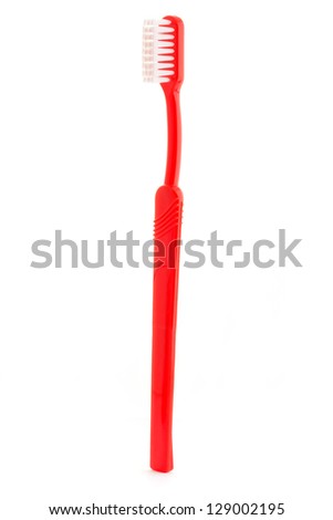 Single red toothbrush on a white background Royalty-Free Stock Photo #129002195