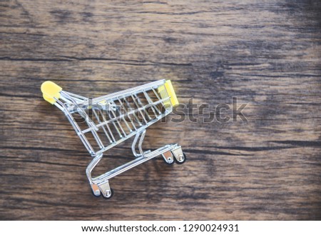 Shopping cart on rustic wooden background / Online shopping Black Friday concept 