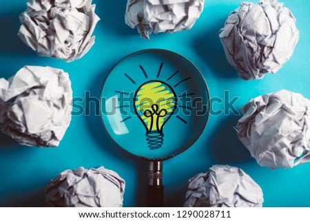 Creative Idea And Innovation Concept with magnifying on blue background.
