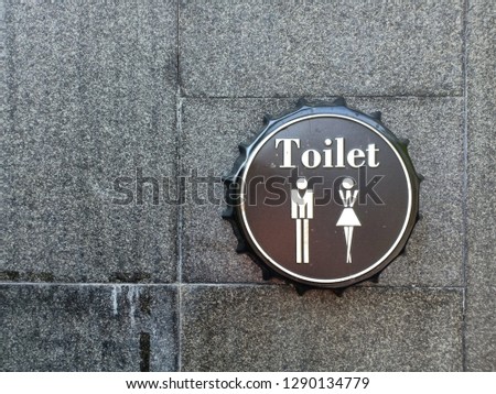 Restroom symbol on the stone texture