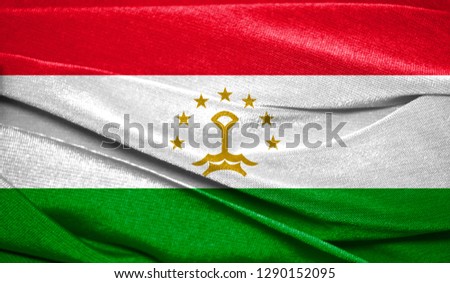 Realistic flag of Tajikistan on the wavy surface of fabric. Perfect for background or texture purposes
