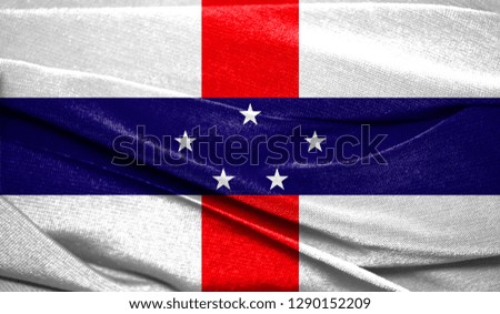 Realistic flag of Netherlands Antilles on the wavy surface of fabric. Perfect for background or texture purposes