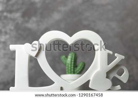 the inscription LOVE on the background of a cactus