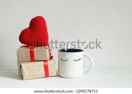 Valentines day gift boxes, toy heart and kawaii coffee cup with cutest funny eyes on white background, cute holiday breakfast concept with copy space 