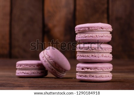 Wedding, St. Valentine's Day, birthday, preparation, holiday. Beautiful pink tasty macaroons on a wooden background