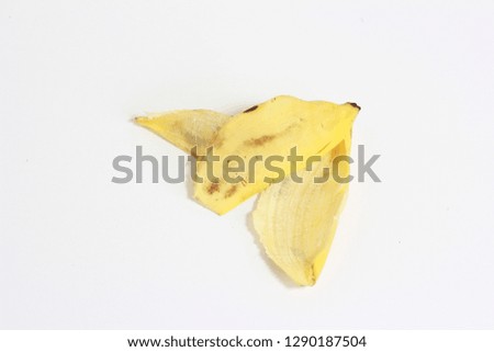 banana skin with eyes over white background.
