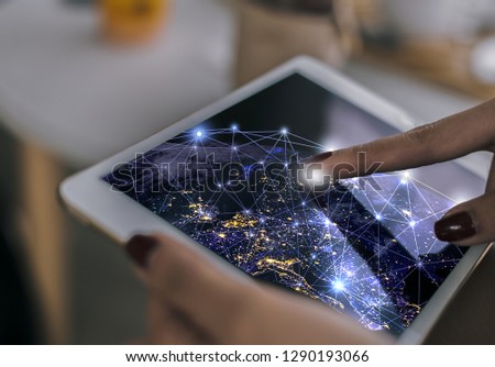 business woman touch the world on the screen tablet,of a sense of science and technology , this image furnished by NASA