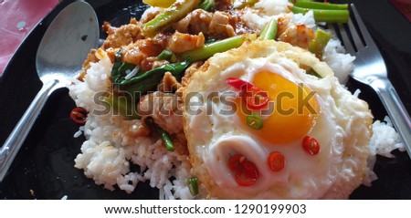 Thai food, rice, kale, pork, fried egg Take pictures using a handheld camera, natural light