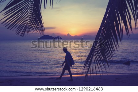 Silhouette of a man walking along the seashore at sunset, man and nature concept, beauty lifestyle freedom vacation vacations