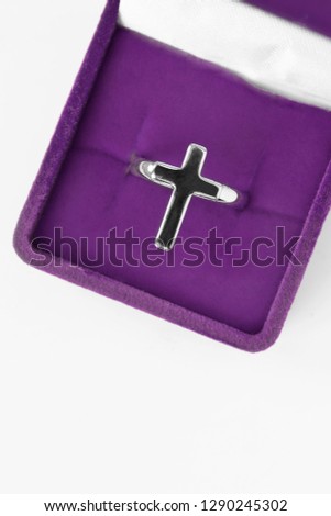 Silver cross ring in purple jewel box closeup