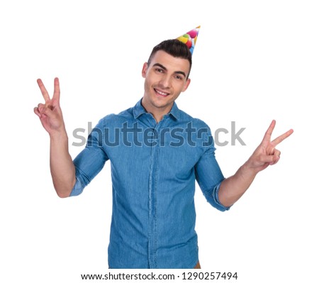portrait of birthday casual man making peace sign while standing on white background