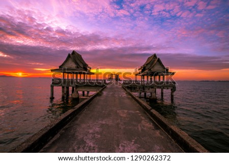The background of the bridge stretches to the sea and has a beautiful evening twilight light, wallpaper, sunset light on each day, seen while traveling, resting during the tourist season.