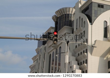 Red color traffic light with buildings in the background. Traffic light wallpaper