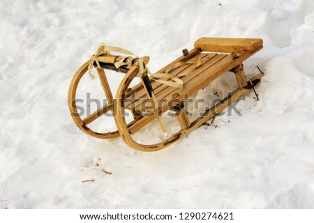 Old wood sled in the snow in winter
