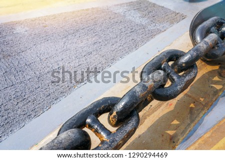 Close up view of big metal anchor chain of battleship.