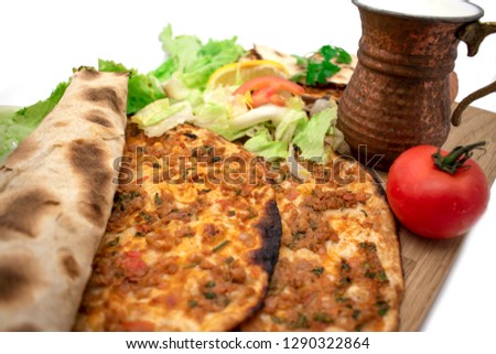 Turkish pizza, lahmacun, isolated on white background. lahmacun on a wooden table. Horizontal. one rolled with fresh garnish on the white surface.Cold buttermilk (ayran) near it.Close up taken,isolate