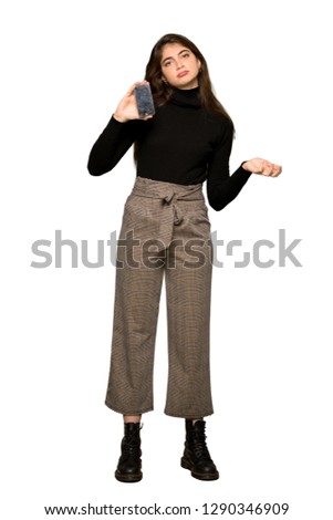 Full-length shot of Pretty girl upset with a broken phone on isolated white background