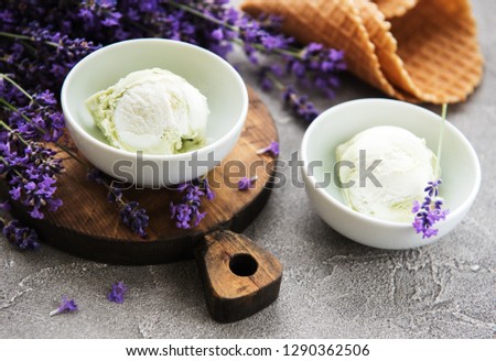 Ice cream and lavender flowers on a stone background