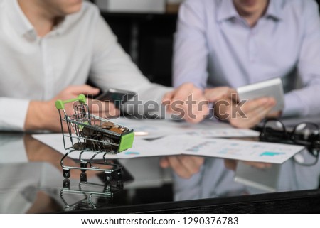 Men's hands with calculator and phone on the background of the documents on the table