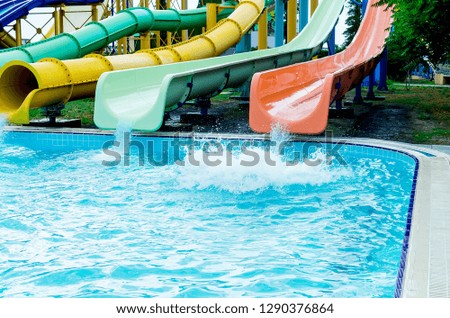 Colorful waterpark tubes and pool in aquapark. Water park slides close up. sunny summer day