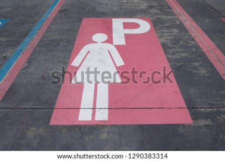 Parking symbol for women on the Concrete road.