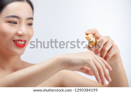 Young asian woman showing skincare products. Hand cream. mock up.