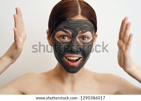 woman in a cosmetic mask of clay