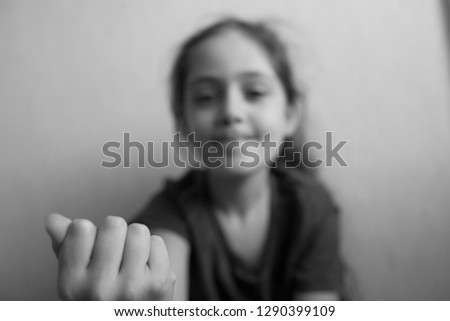 Little girl shows fist