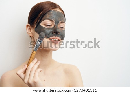 woman apply cosmetic clay on face