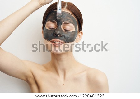 woman puts on a corset mask